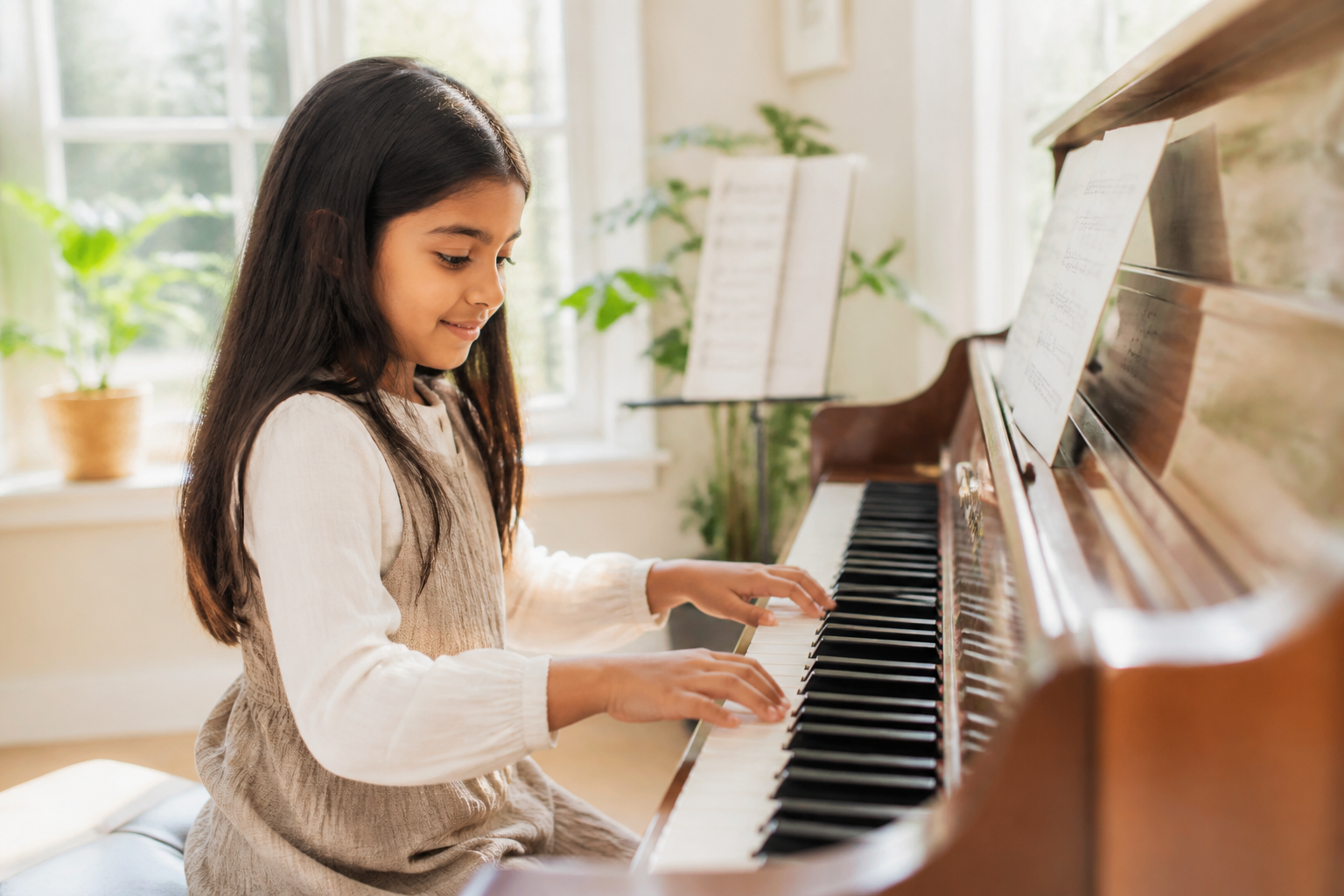 A child playing piano in a brightly lit room